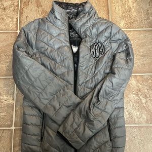 Gray puffy jacket with CDD initials